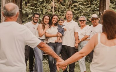 a group of people holding hands in front of trees